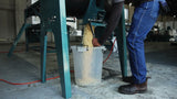 The Roff 70-litre horizontal batch mixer emptying conditioned maize into a bucket