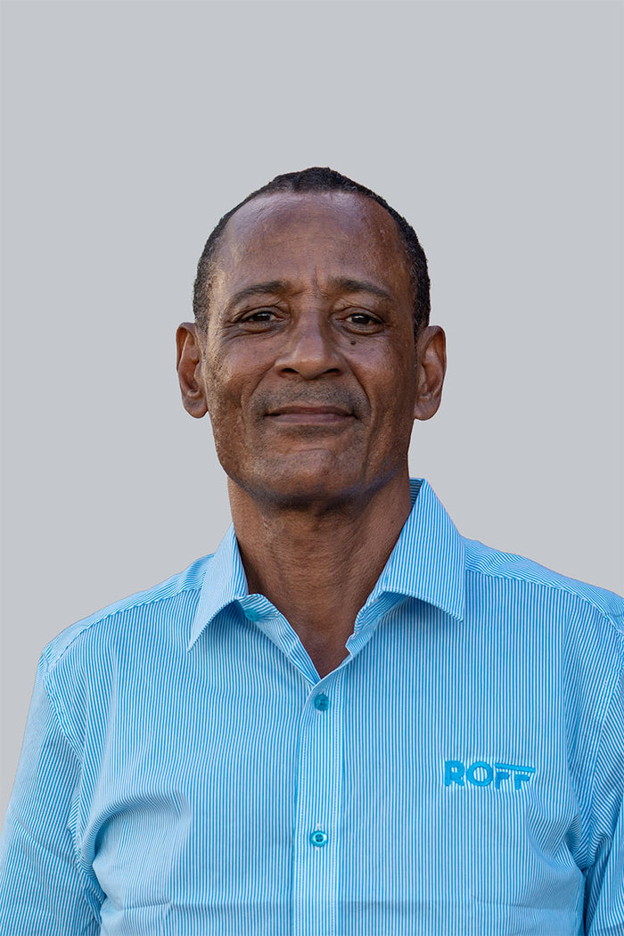 Man wearing a light blue shirt with 'ROFF' logo against a gray background