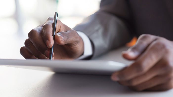 Business man working on tablet with stylus